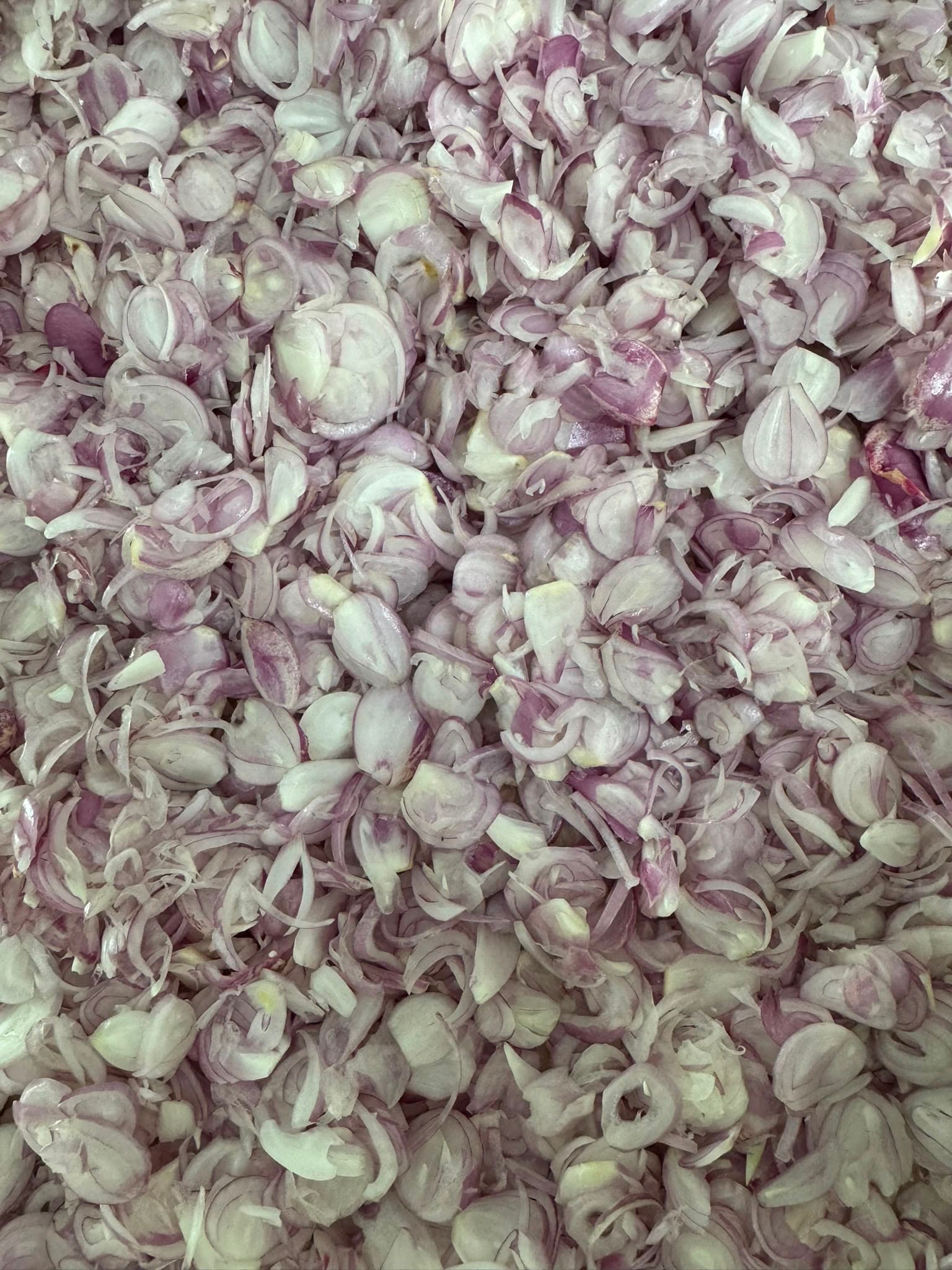 Shallots sliced thin by hand in our kitchen