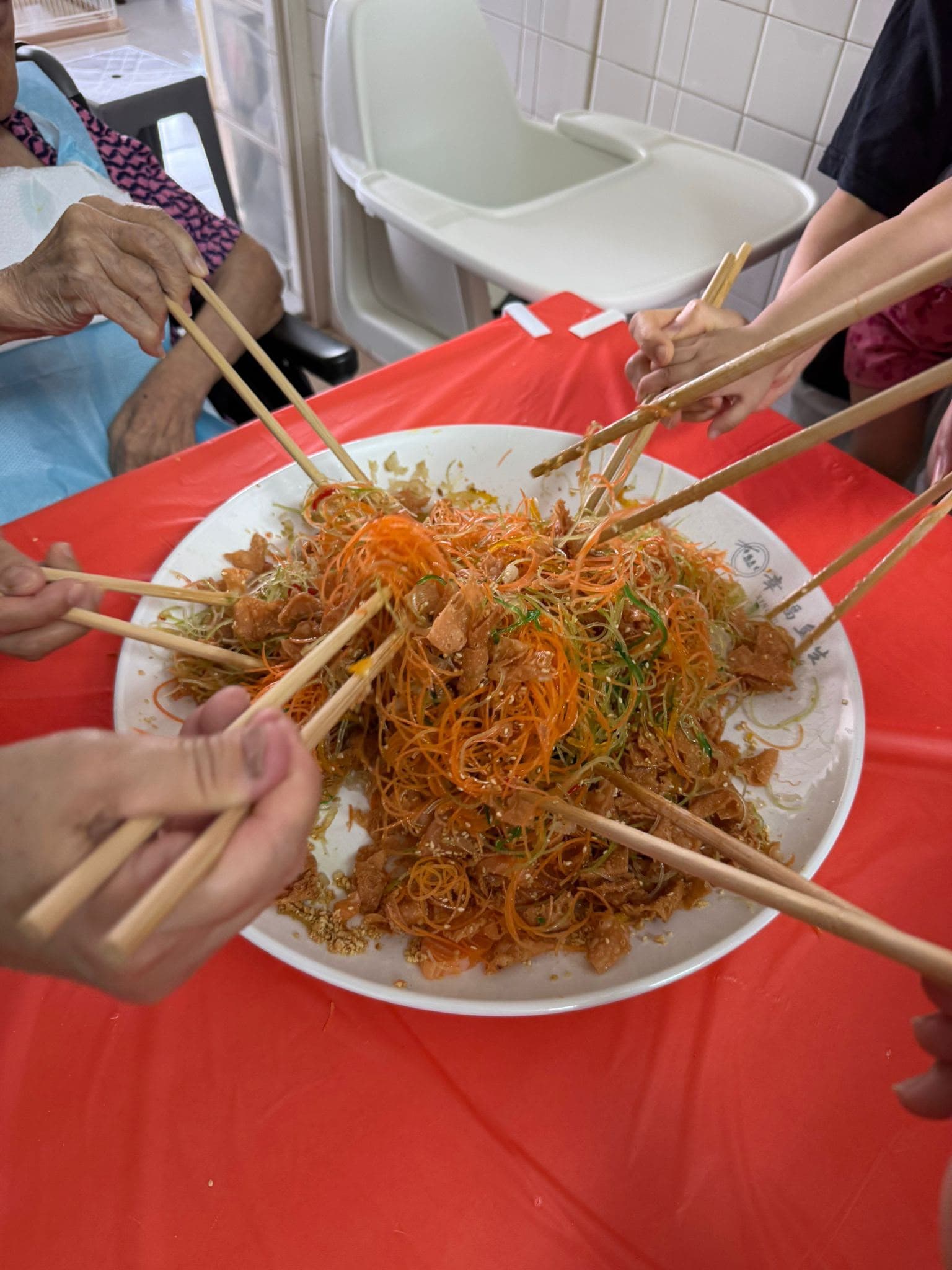 A family tossing yusheng together